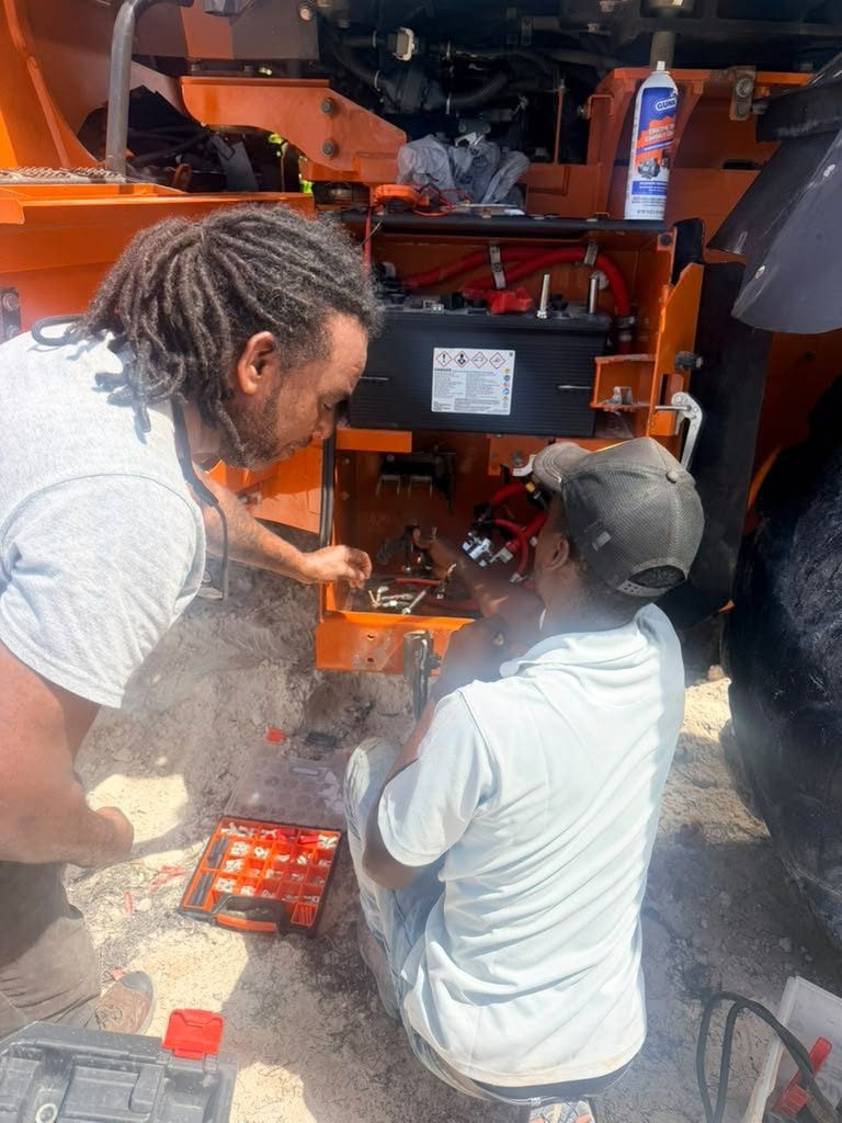 GenTech technicians performing scheduled battery maintenance