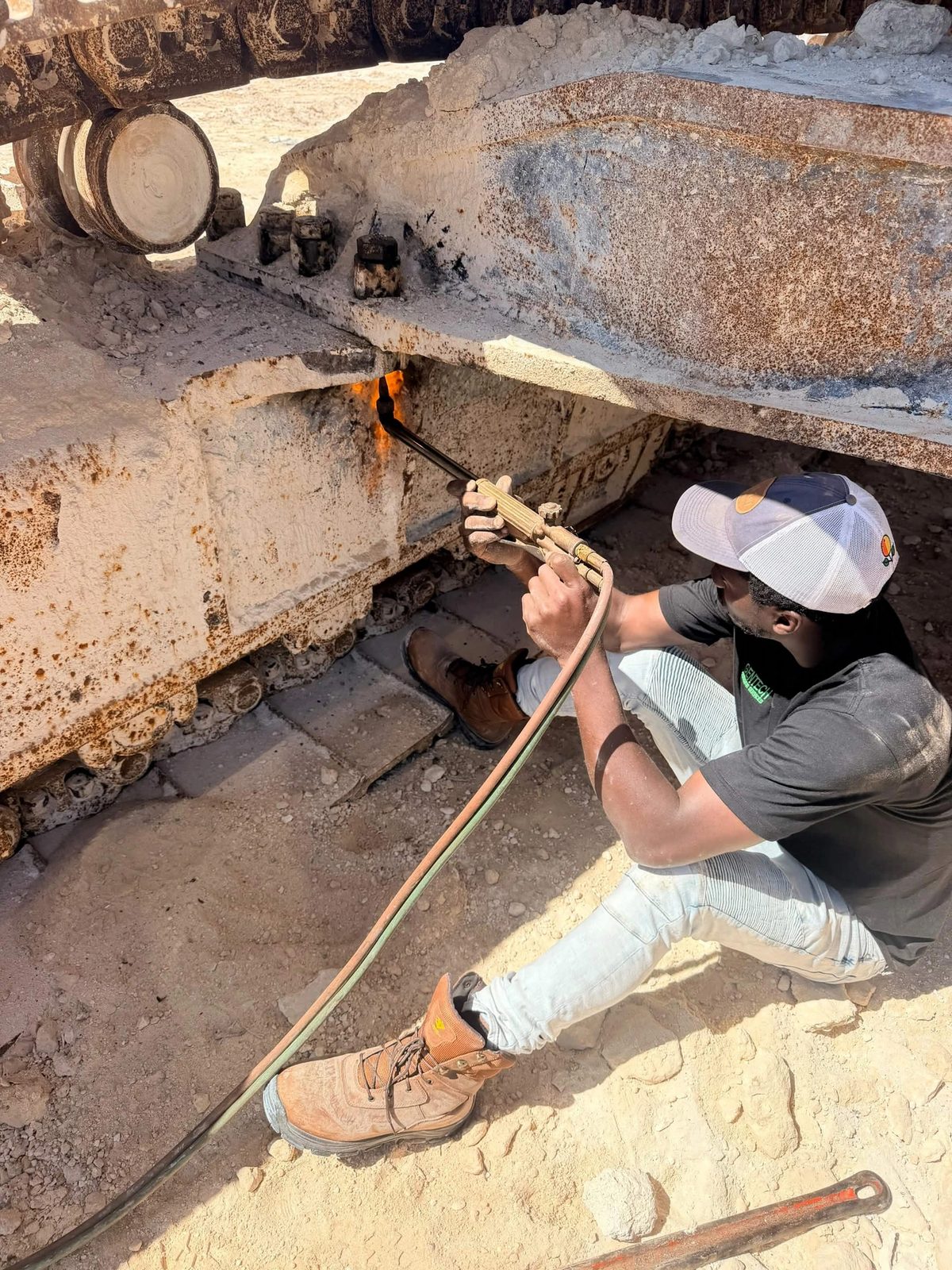 GenTech technician performing torch repair on heavy equipment